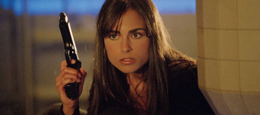 A screencap from the movie D.E.B.S. It depicts Lucy Diamond with a gun in her hand.