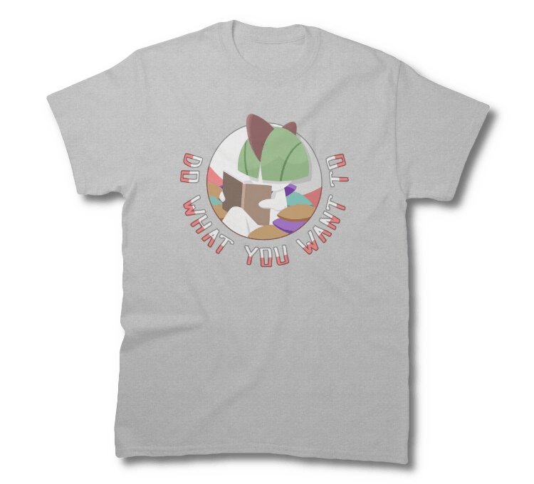 A shirt depicting a Ralts pokemon, sitting in a pile of cushions, reading a book, with the catchphrase around it reading 'Do What You Want To'