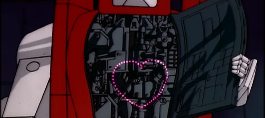 A screencap from the TV episode 'The Girl Who Loved Powerglide.' It shows Powerglide holding his chest open to show flashing lights in a heart shape. He has a really tiny hand.