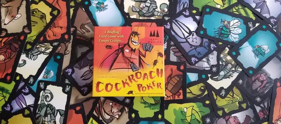 The box and many cards from the game Cockroach Poker