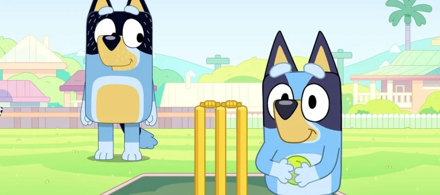 A screencap from the TV series Bluey, episode 'Cricket.' It shows Bluey holding a tennis ball and preparing to bowl while her dad Bandit looks on with a smile.